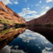 Reflections of cliffs and clouds in the Colorado River in Glen Canyon, AZ